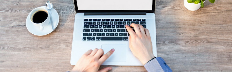 man typing on a laptop